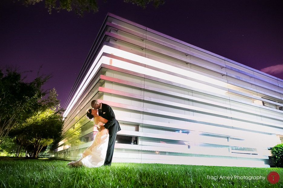 cool architectural lines behind couple in colorful romance session in Uptown Charlotte