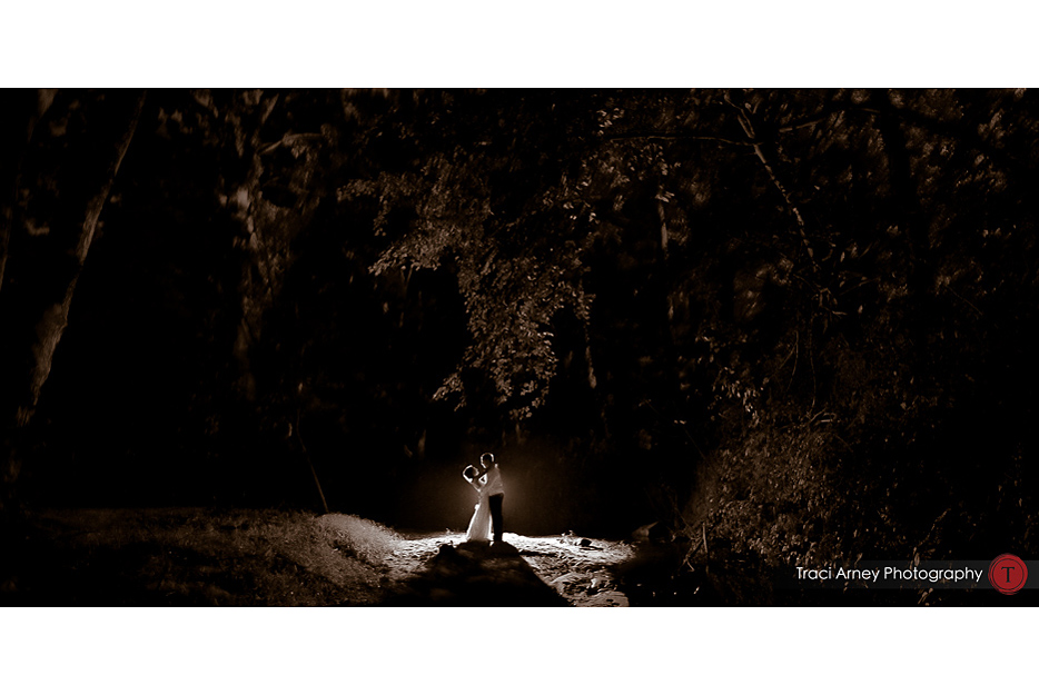 Bride and groom in creek backlit during romance session in Winston-Salem, NC