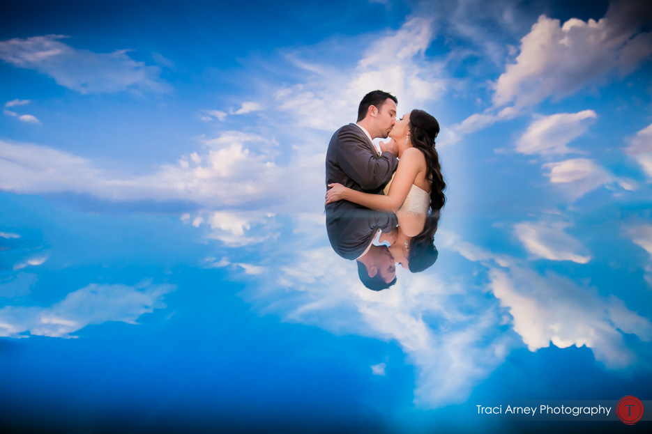 bride and groom surrounded by clouds and blue sky at Grandover Resort wedding in Greensboro, NC.