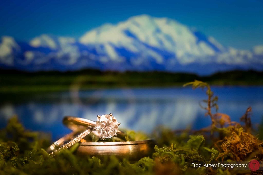 Ring shot of wedding rings in front of wonder lake , denali national park, Alaska